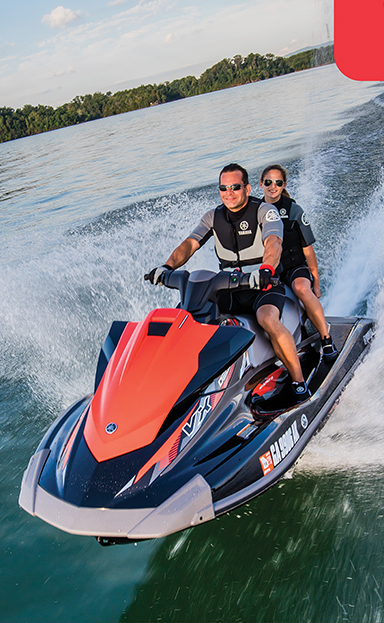 Image of 2 people on a personal watercraft.
